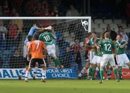Mark Tyler punches the ball away from the head of Declan Walker