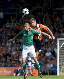 Janos Kovacs climbs above Andy Bishop to head the ball clear