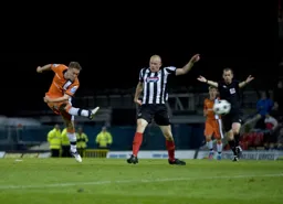 Jake Robinson fires a long range shot at goal