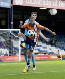 Stuart Fleetwood shields the ball under pressure from future Hatter Andy Parry