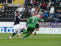 Andre Gray knocks the ball past Paul Farman but does not find the target