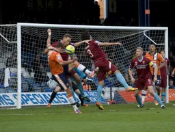 Andre Gray looks on as Janos Kovacs causes some panic in the Nuneaton defence