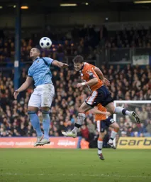 Simon Ainge heads the ball clear