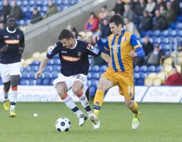 Jonathan Smith tussles for the ball with Chris Clements