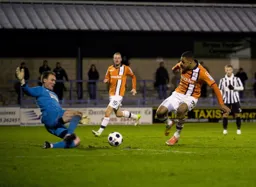 Jason Matthews blocks this Andre Gray`s effort