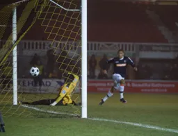 Andre Gray slams the ball past Alan Julian to level the score at 1-1