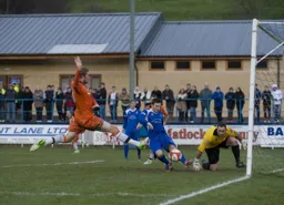 An outstretched Scott Rendell cannot quite block a last ditch clearance