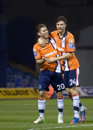 Scott Neilson celebrates scoring the first goal with Jonathan Smith
