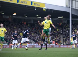 Jake Howells in a heading duel with Elliott Bennett