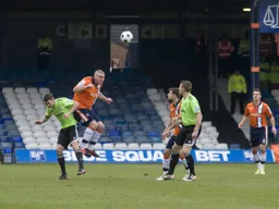 Steve McNulty heads the ball clear