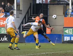 Wayne Thomas sends a header towards the goal