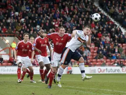 Simon Ainge up with the attack beats Stephen Wright to the ball