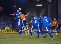 Simon Ainge challenges for the ball