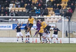 Mark Tyler punches the ball clear under pressure from Rory McAuley and Nathan Blissett