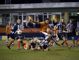 Grimsby scramble the ball away from Dave Martin and Andre Gray