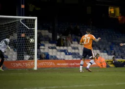 Andre Gray watches his shot hit the net for his and Town`s first goal