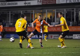 Dan Walker knocks the ball past Ryan Blake