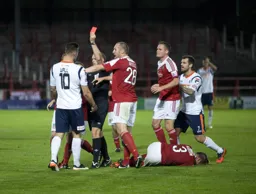 The red card is brandished to Alex Wall