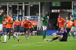 The players celebrate the winner as goalscorer Mark Cullen wheels away