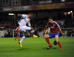 Andre Gray nutmegs the defender