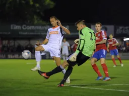 Paul Benson does battle with the goalkeeper