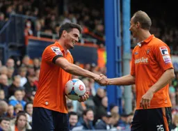 Ronnie Henry and Paul Benson share a handshake to celebrate a comfortable win