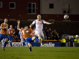 Mark Cullen is challenged for the ball