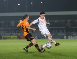 Matthew Robinson challenges for the ball