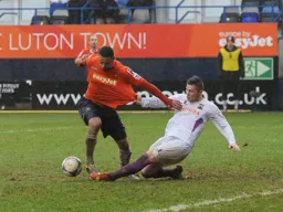 Andre Gray having his shirt pulled