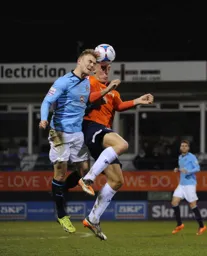 Alex Wall challenging for the ball