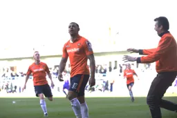 Andre Gray celebrates after scoring