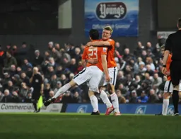Matthew Robinson celebrates his equaliser with Cameron McGeehan