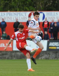 Matthew Robinson wins the ball