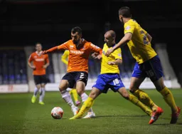 Alex Lawless holds off former Luton player Keith Keane