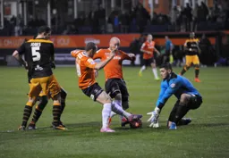 Rick Miller and Luke Guttridge challenge the keeper
