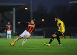 Shaun Whalley attacks a Burton defender