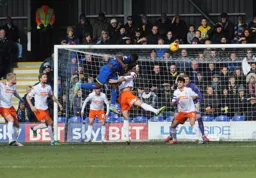 All eyes on the ball as Alex Lacey challenges
