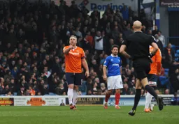 Steve McNulty corrects the referee
