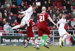 Luke Wilkinson clears as Lewis Kinsella looks on