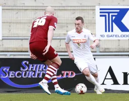 Ricky Miller attacks the defender