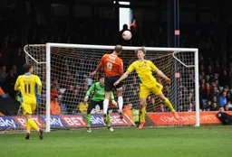 Paul Benson outjumps the defender