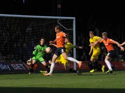 Paul Benson goes close watched by Cameron McGeehan