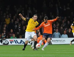 Alex Lawless tussles in midfield