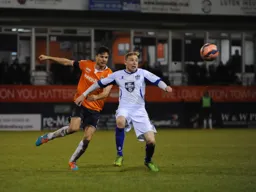 Jonathan Smith duels in midfield