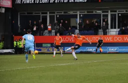 Andy Drury scores watched by Shaun Whalley