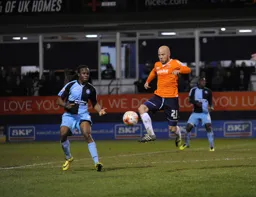 Luke Guttridge leaps to control the ball