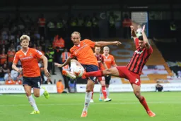 Paul Benson and Danny Rose go for the ball with raised boots