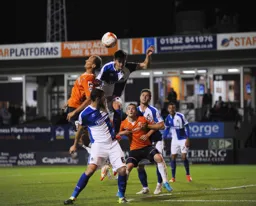 Paul Benson and future Hatter Tom Lockyer challenge for a high ball