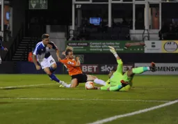 Craig Mackail-Smith slides in but Aaron Chapman gathers the ball
