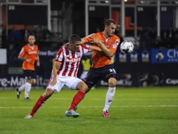 Luke Wilkinson tangles with Jon Walters